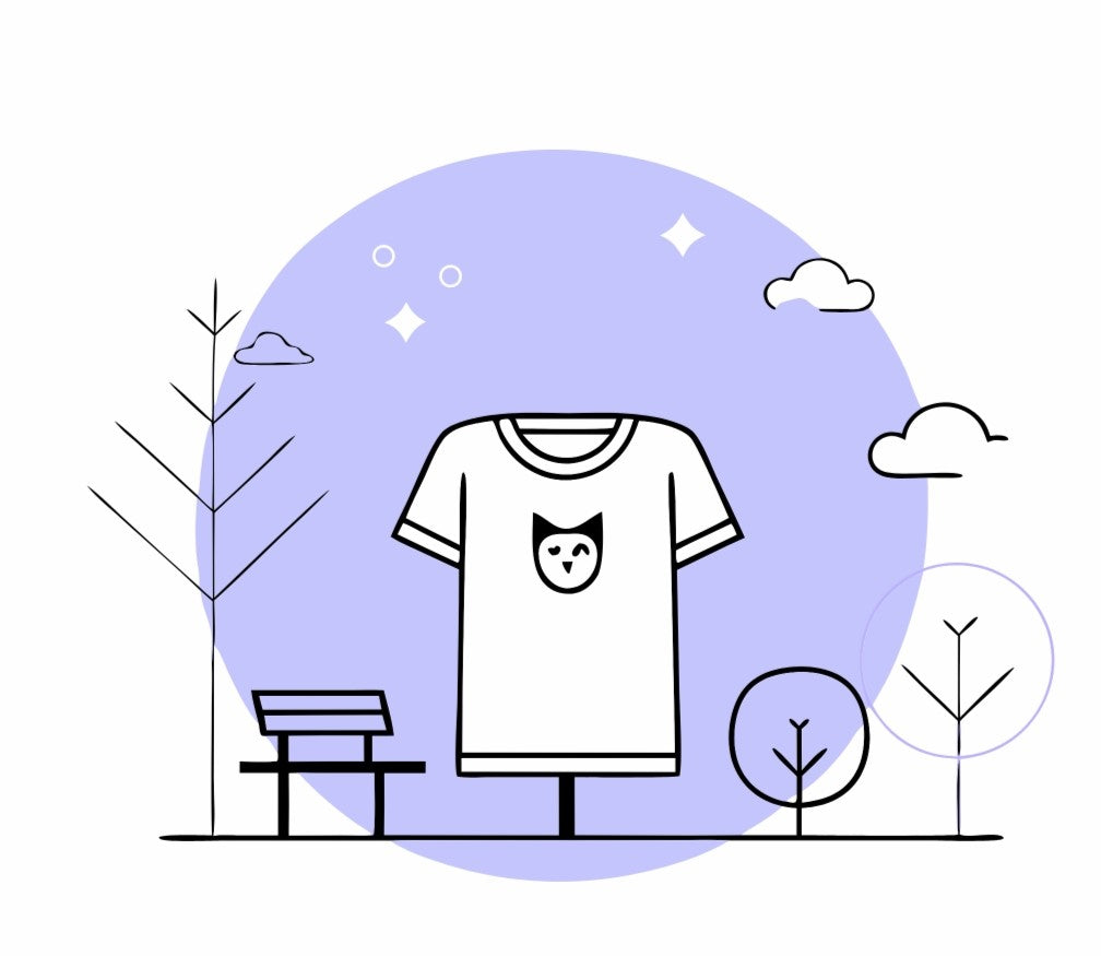 Model wearing organic mid-weight tee with embroidered owl, standing outdoors among fall leaves. Ethical USA fashion for whimsical style.